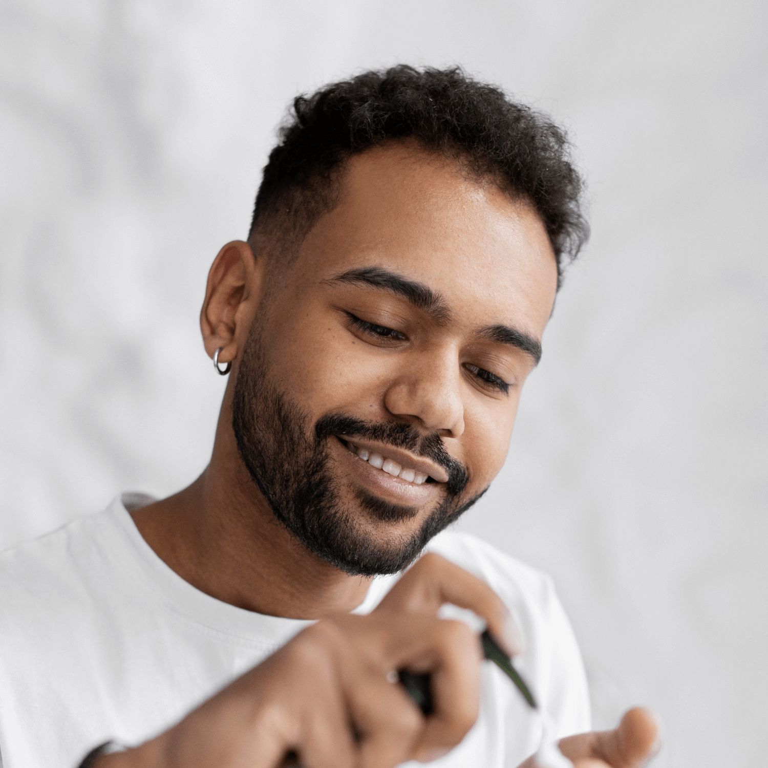 A man applying our Growth Activator serum